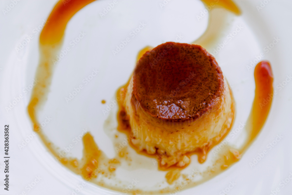 delicious flan with egg and caramel on the white plate delicious flan with egg and caramel on the white plate