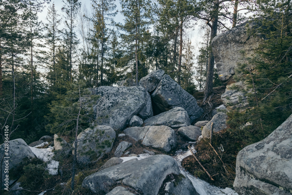 A pile of snow next to a rock wall