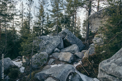 A pile of snow next to a rock wall