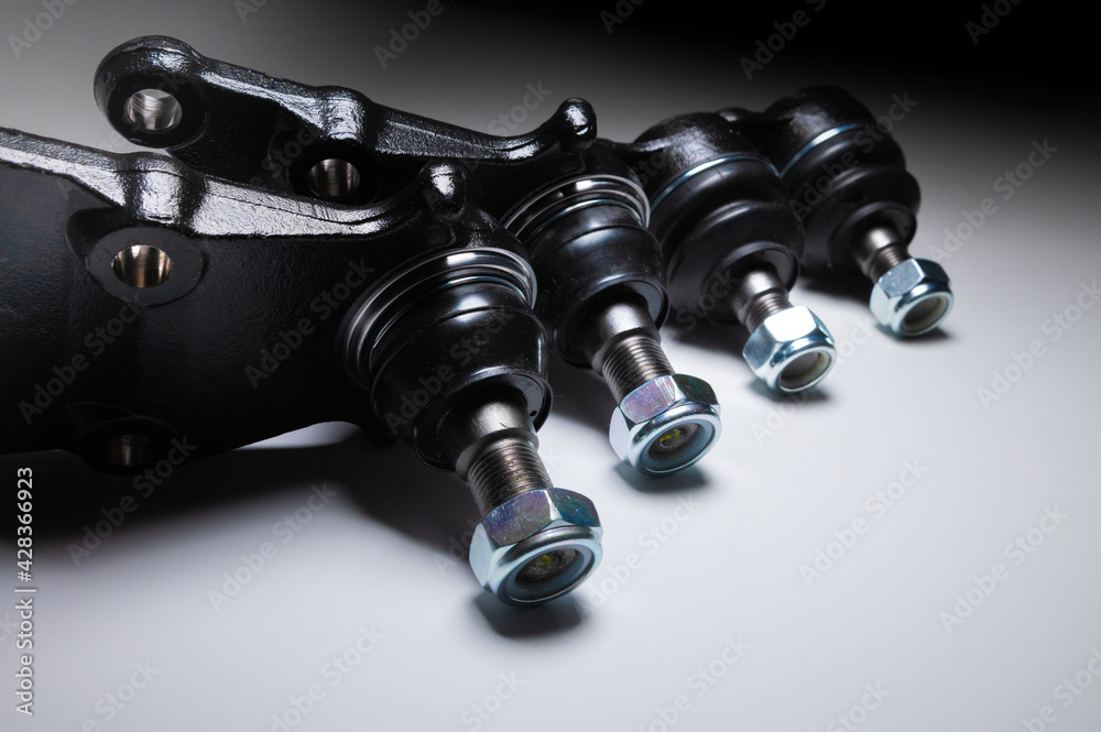 front suspension ball joint new on gray background. Spare parts kit for SUV front suspension ball joint new on gray background. Spare parts kit for SUV