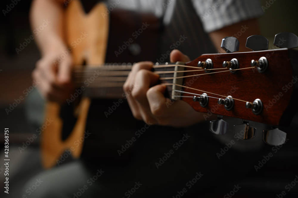 Man playing acoustic guitar, cover for online courses, learning at home. Man playing acoustic guitar, cover for online courses, learning at home.