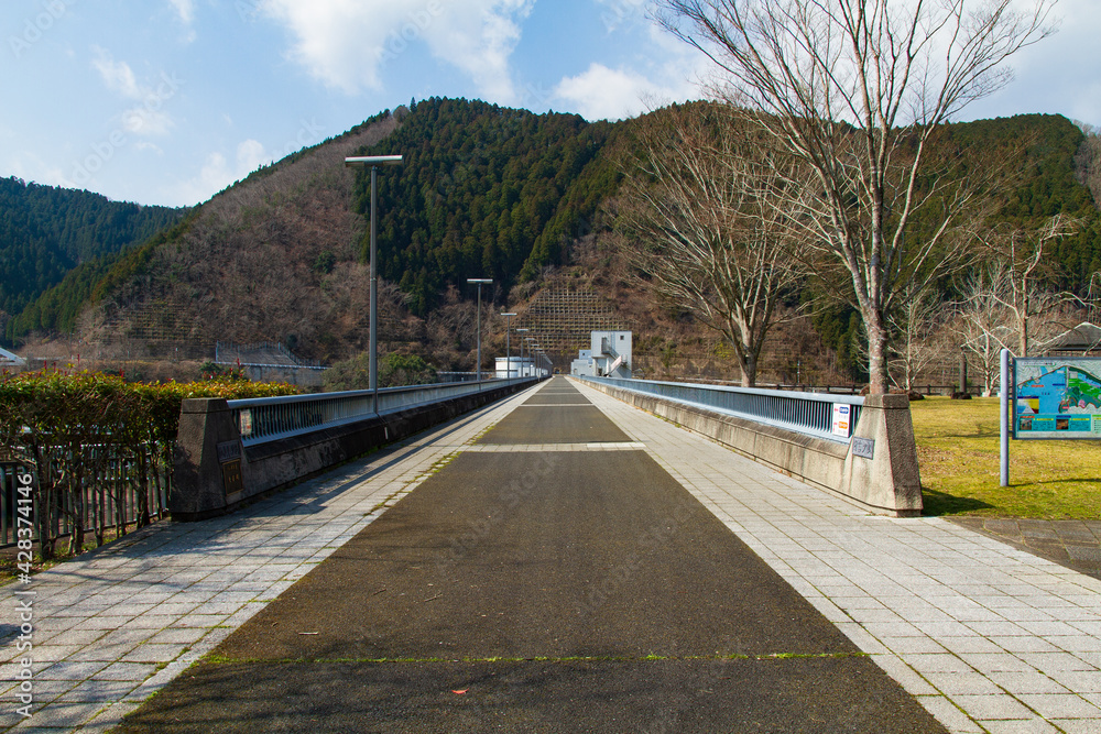 The road above the weir of the Hiyoshi Dam in Nantan City, Kyoto Prefecture, Japan The road above the weir of the Hiyoshi Dam in Nantan City, Kyoto Prefecture, Japan