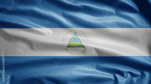 Nicaraguan flag waving in the wind. Close up Nicaragua banner blowing soft silk.