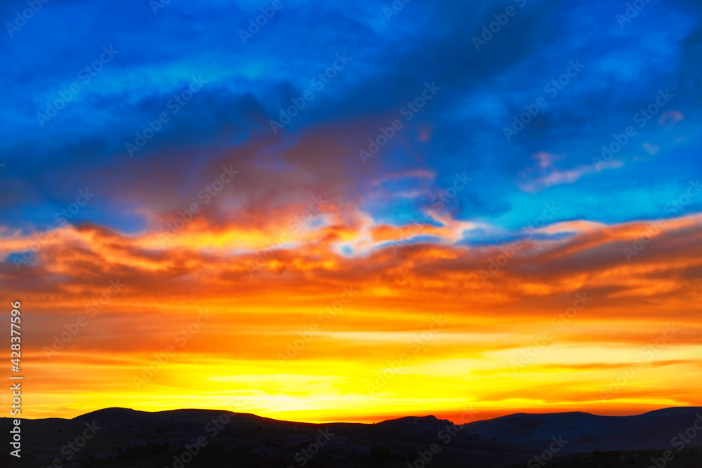 Sunset sky with clouds at sunset