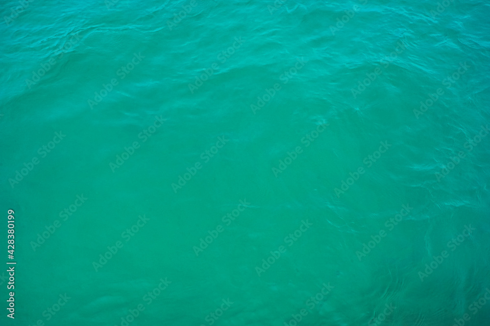 Surface texture sea blue emerald green. Turquoise sea water surface background.
