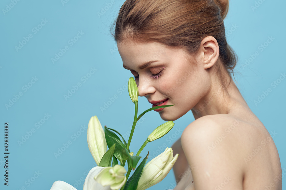 charming woman with white flowers on blue background portrait cropped view charming woman with white flowers on blue background portrait cropped view