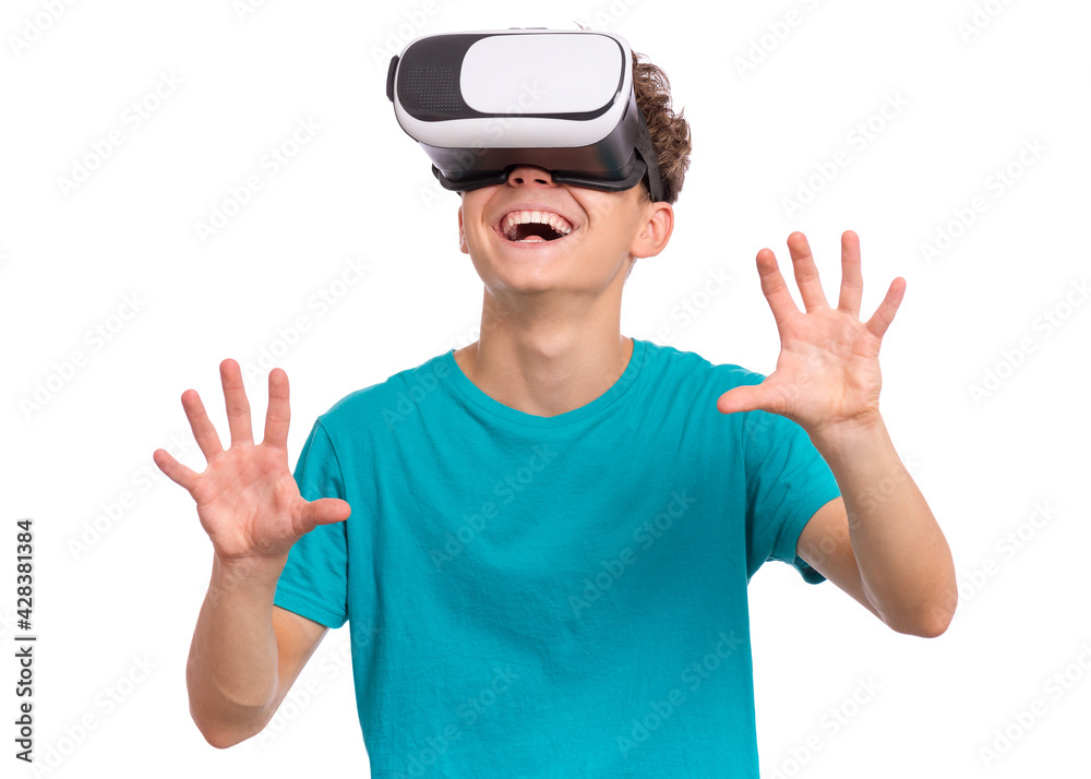 Portrait of young caucasian teen boy using virtual reality goggles. Funny teenager looking in VR glasses. Handsome child experiencing 3D gadget technology, isolated on white background Portrait of young caucasian teen boy using virtual reality goggles. Funny teenager looking in VR glasses. Handsome child experiencing 3D gadget technology, isolated on white background