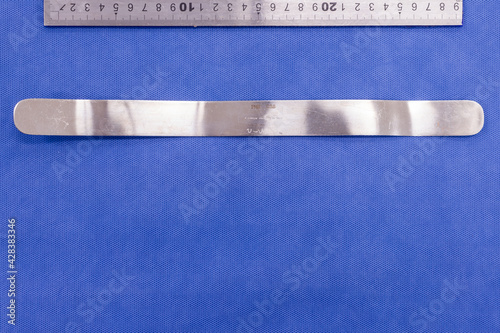 Fotografie Malleable retractor on a blue background