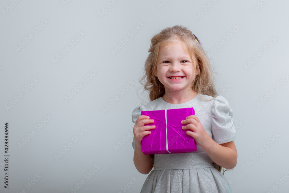 little girl holding a gift on a white background celebrating her birthday little girl holding a gift on a white background celebrating her birthday