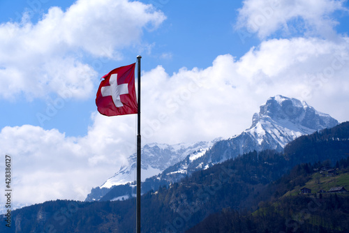 Swiss Flag blowing in the wind. Photo taken April 14th, 2021, Brunnen, Switzerland.