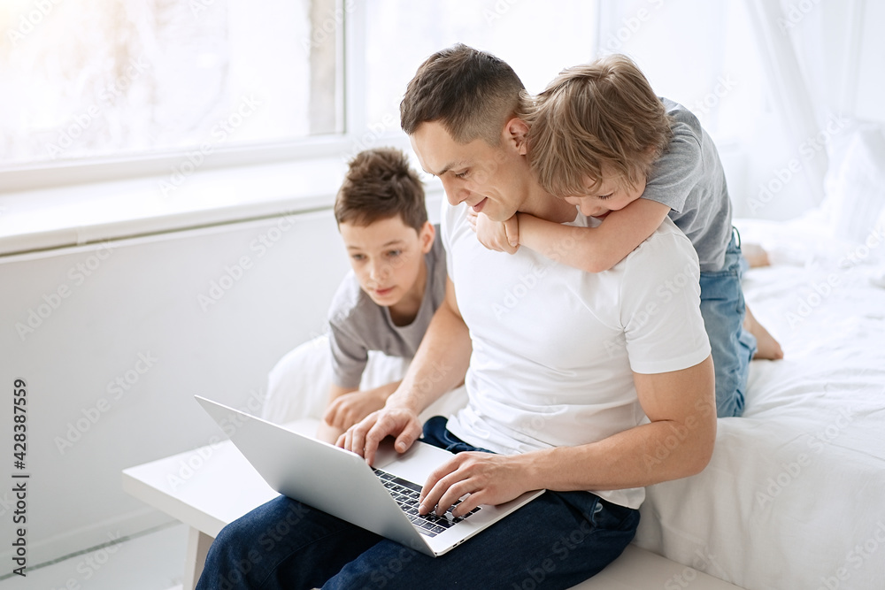 Work from home. Father working with children and laptop computer at home. Quarantine and closed school during coronavirus outbreak. Work from home. Father working with children and laptop computer at home. Quarantine and closed school during coronavirus outbreak.