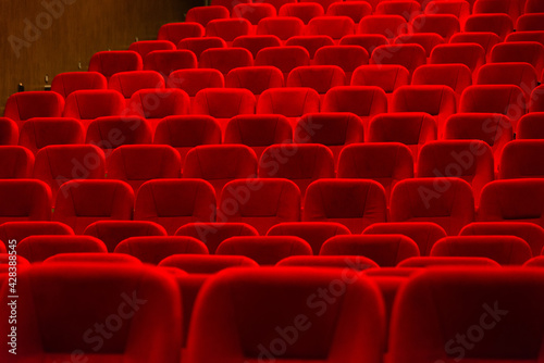 empty red velvet seats in cinema auditorium
