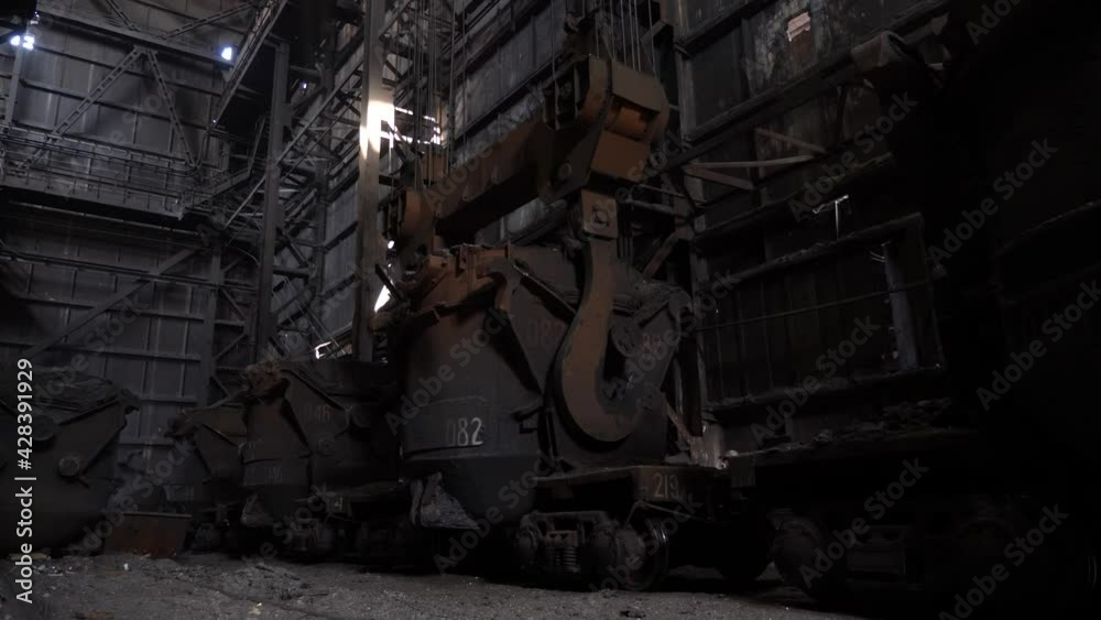 Converter shop. Lifting crane lifts a bucket with cast iron Converter shop. Lifting crane lifts a bucket with cast iron