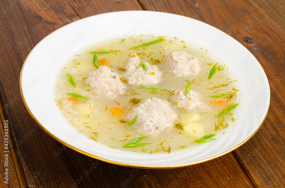 White plate of meatball soup. Studio Photo White plate of meatball soup. Studio Photo