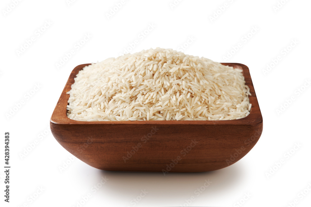wooden bowl filled up with white rice-raw wooden bowl filled up with white rice-raw
