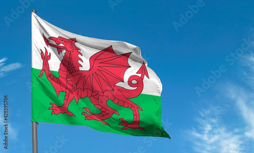 Photography Flag of Wales with red dragon waving against blue sky, Cardiff