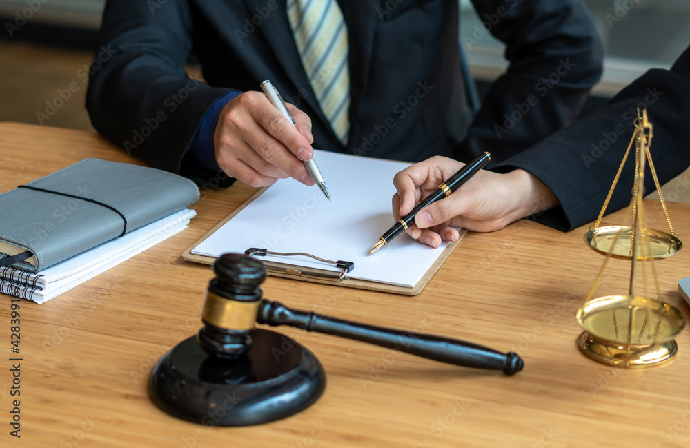 Professional male lawyer or counselor discussing negotiation legal case with client meeting with document contract in office, law and justice, attorney, lawsuit concept. Professional male lawyer or counselor discussing negotiation legal case with client meeting with document contract in office, law and justice, attorney, lawsuit concept.