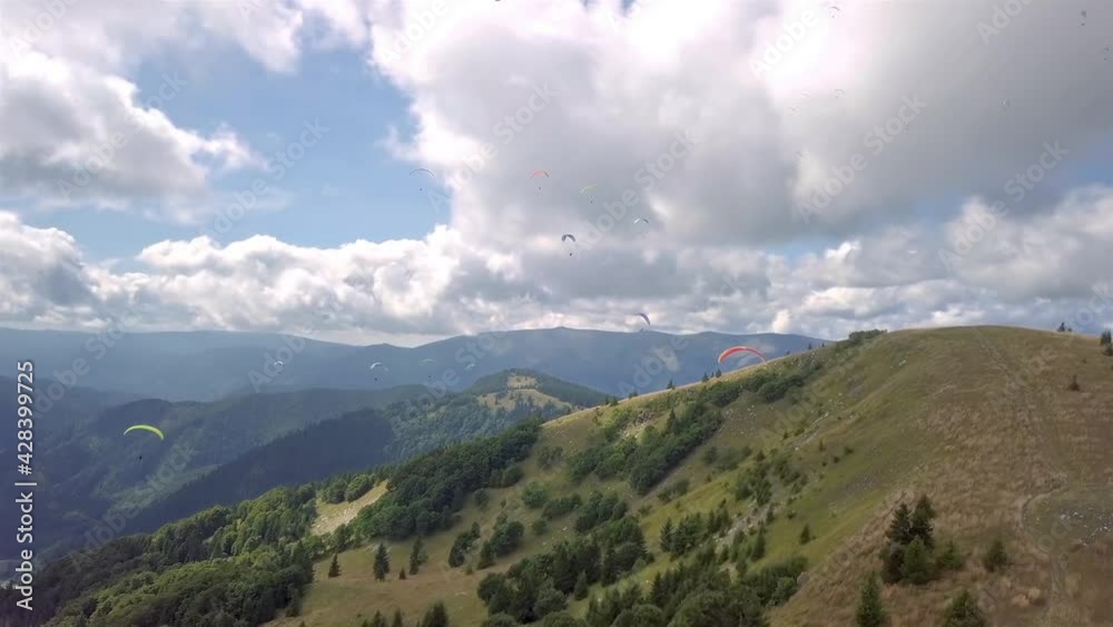 Paragliders flying in sunny mountain in summer nature landscape, Paragliding Adrenaline Adventure Aerial view Paragliders flying in sunny mountain in summer nature landscape, Paragliding Adrenaline Adventure Aerial view
