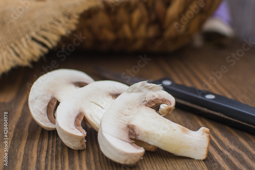 Sliced ​​champignons close-up on a wooden board. Cooking vegetarian food.