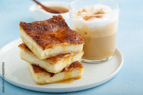 Sopapilla cheesecake bars with cinnamon drizzled with honey photo