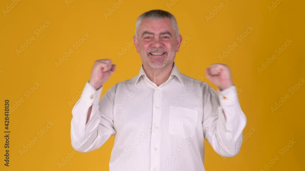 Handsome middle aged man asking and looking with amazed face against yellow studio background. People sincere emotions, lifestyle concept. Handsome middle aged man asking and looking with amazed face against yellow studio background. People sincere emotions, lifestyle concept.