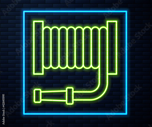 Glowing neon line Fire hose reel icon isolated on brick wall background. Vector