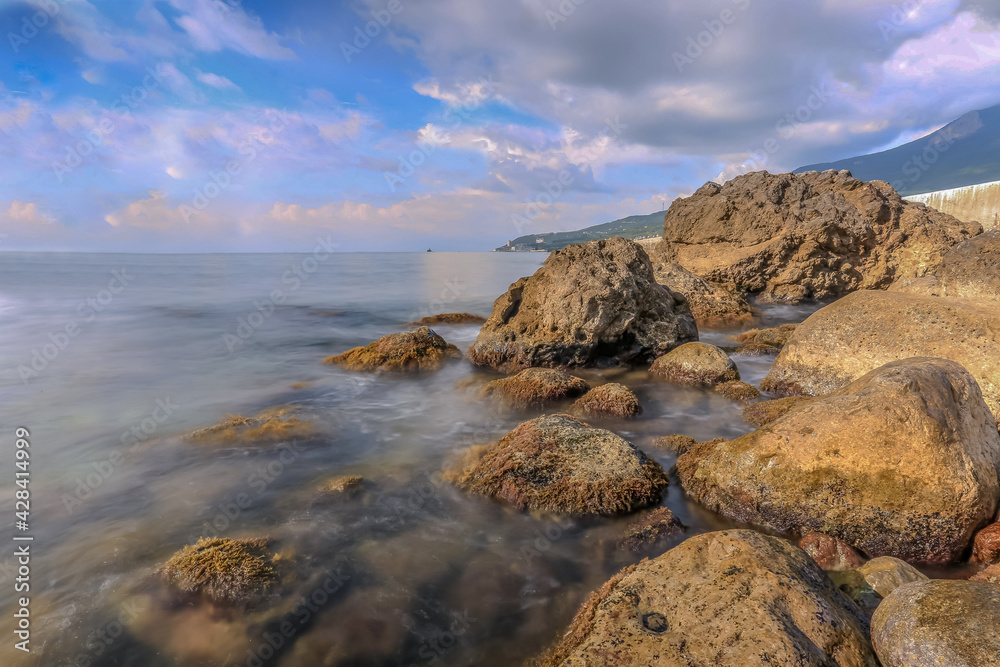 Rocks in the Crimea at sunset. Beautiful sunset on the sea. Crimean landscape. Evening on the Black Sea. Adalara rocks in Gurzuf. Rocks in the Crimea at sunset. Beautiful sunset on the sea. Crimean landscape. Evening on the Black Sea. Adalara rocks in Gurzuf.