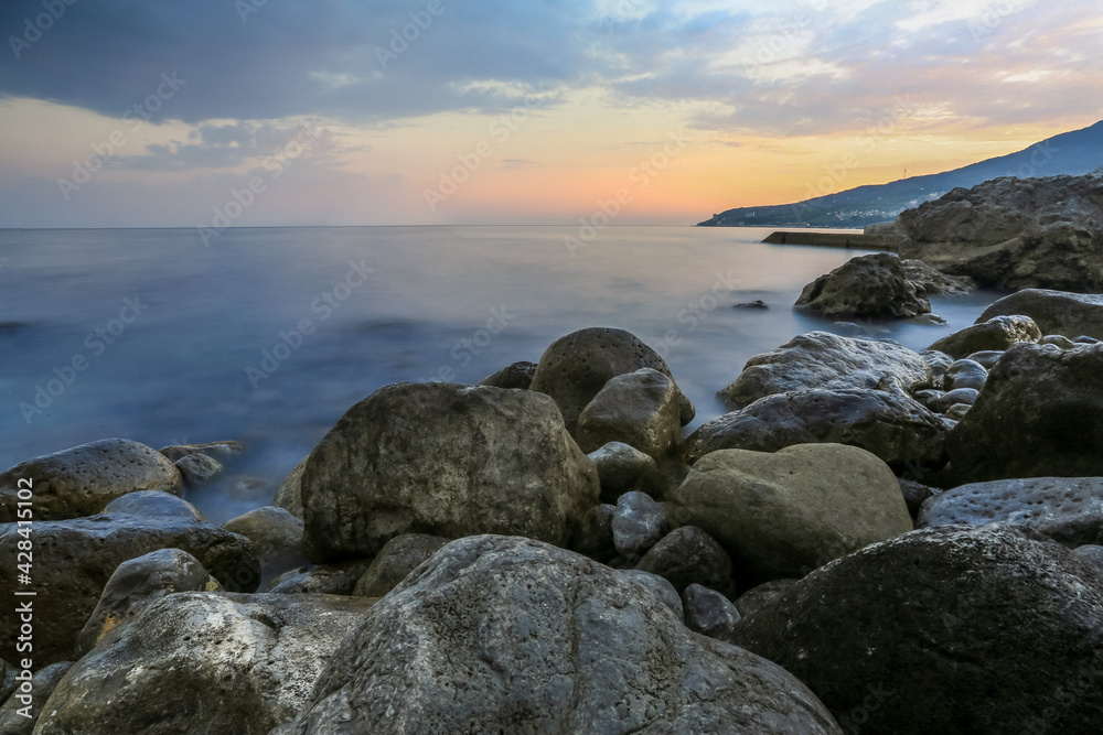 Rocks in the Crimea at sunset. Beautiful sunset on the sea. Crimean landscape. Evening on the Black Sea. Adalara rocks in Gurzuf. Rocks in the Crimea at sunset. Beautiful sunset on the sea. Crimean landscape. Evening on the Black Sea. Adalara rocks in Gurzuf.