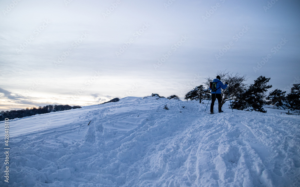 Walking in snow covered mountains in winter