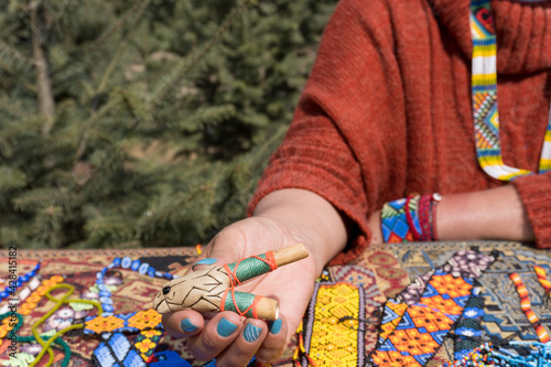 Female selling different decorative items and accessories - huichol art photo