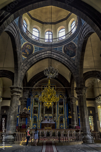 Vertical shot of an ornate church altar with golden chande photo
