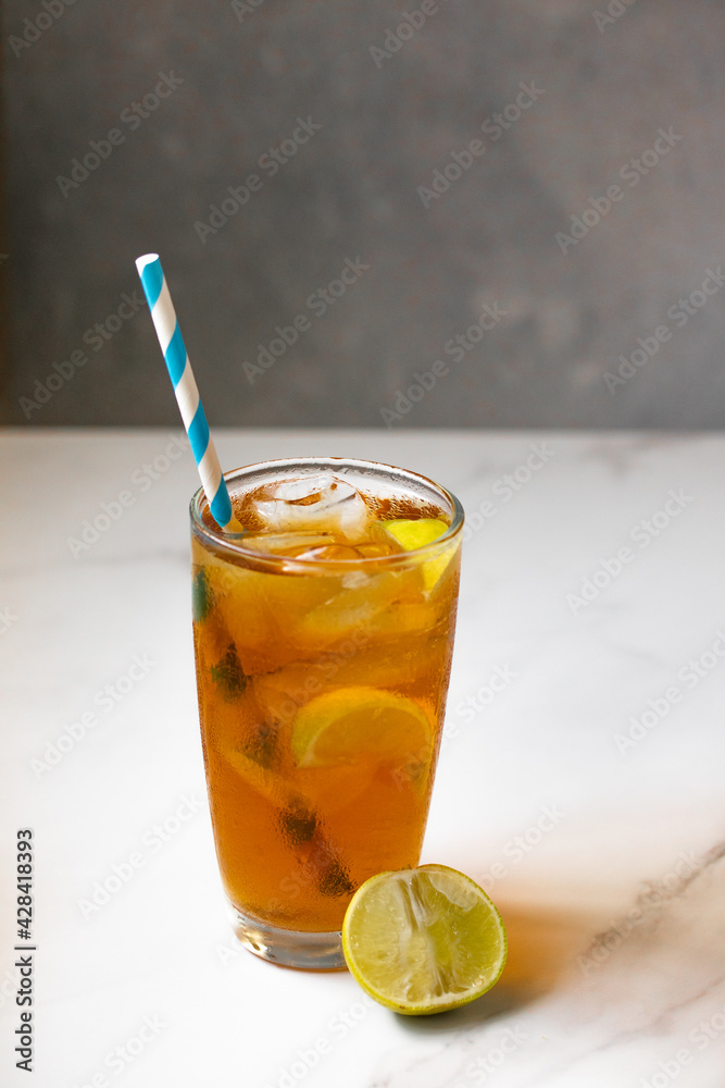 Thai style sweet iced lemon tea on a gray background. Thai style sweet iced lemon tea on a gray background.