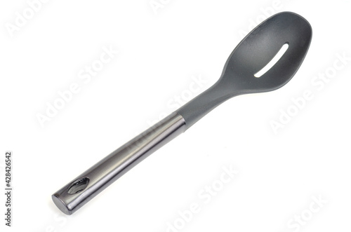 Plastic culinary black spoon, slotted spatula, kitchen gadget. Kitchen utensil. Isolated