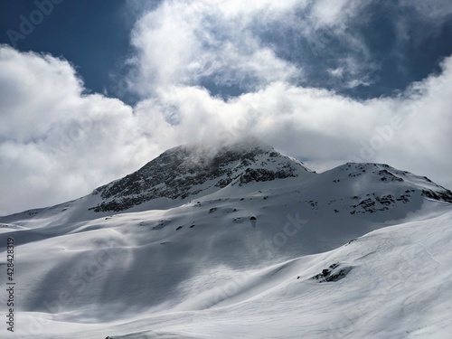 View of the cloud-covered Fanellhorn in the canton of Graubunden. Great ski tour above Valles. Swiss mountaineering
