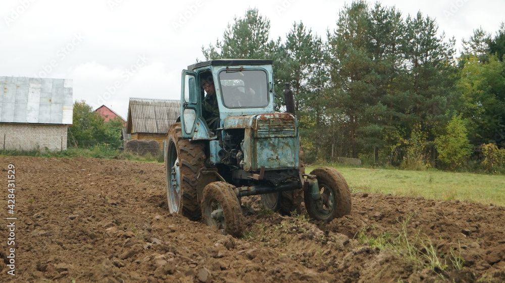 tractor ploughs arable land, an agricultural concept tractor ploughs arable land, an agricultural concept