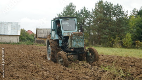 tractor ploughs arable land  an agricultural concept