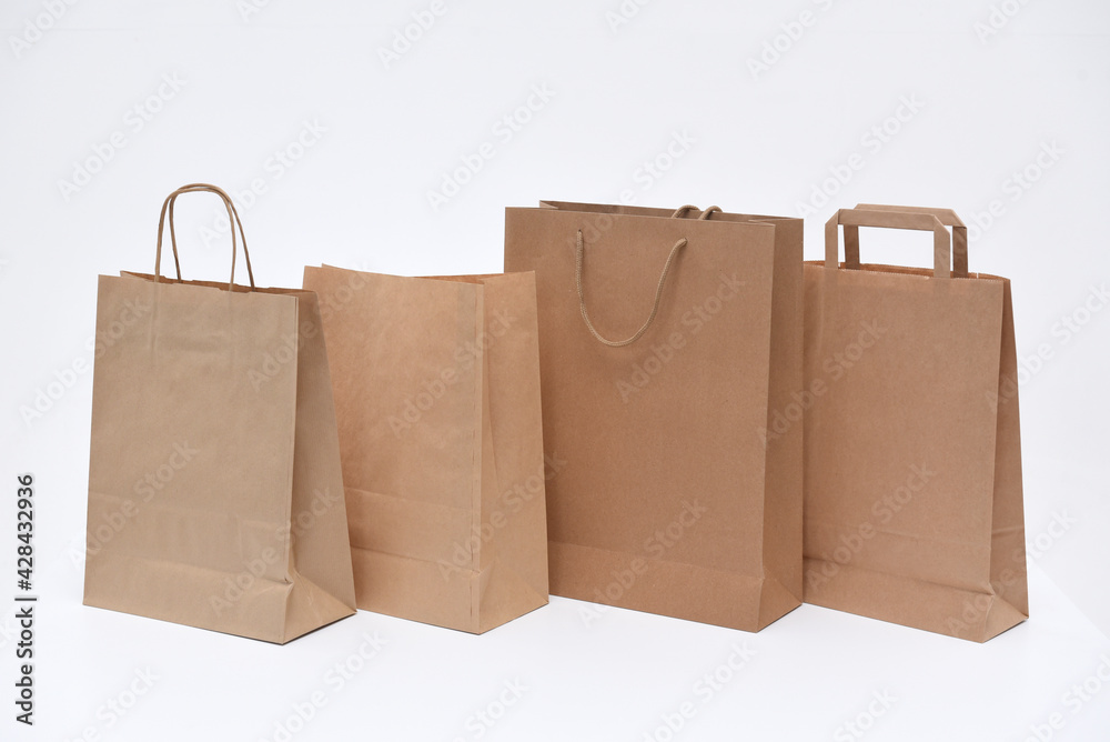 Four eco-friendly paper bags for gifts or packaging on a white background Four eco-friendly paper bags for gifts or packaging on a white background