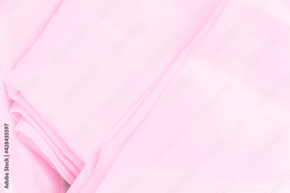 Pink pieces of fabric as background. Sheets or bed linen