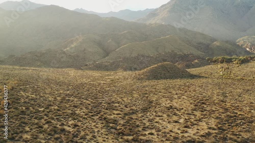 Rising in front of desert mountains