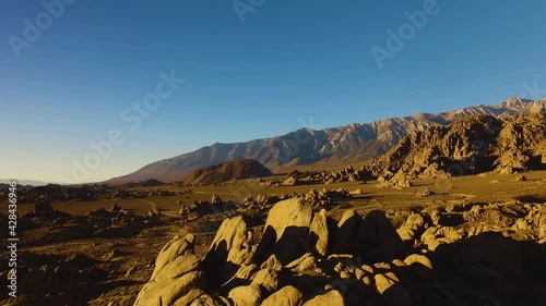  rotating shot of large rock formation in an expansive mountain valley