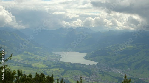 Time Lapse aerial view on clear-water lake in the Swiss Alps. A scenic landscape of snow-capped peaks and lush greenery. Lake Sarnen, Canton Obwalden, Switzerland. photo