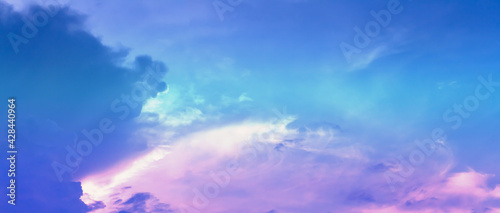 Soft cloud on sky subtle background colorful pastels tone with blue, purple and white color. The light of the sun on evening.