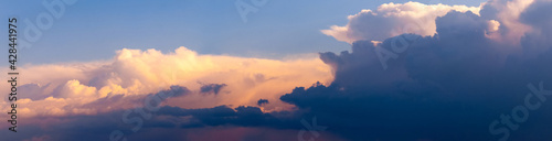 Panorama of the evening sky with dark and light sunlit sky. The sky at sunset