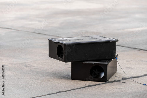 Poison rat trap box on the floor. Outdoor poison rat station in factory.