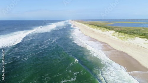 tracking shot down shoreline of private beach