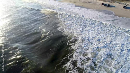 tracking shot on water washing up to the shore