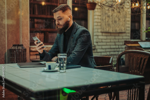 Businessman using a smartphone ina coffee shop