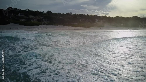 Wide aerial push in shot of the ocean to the shore