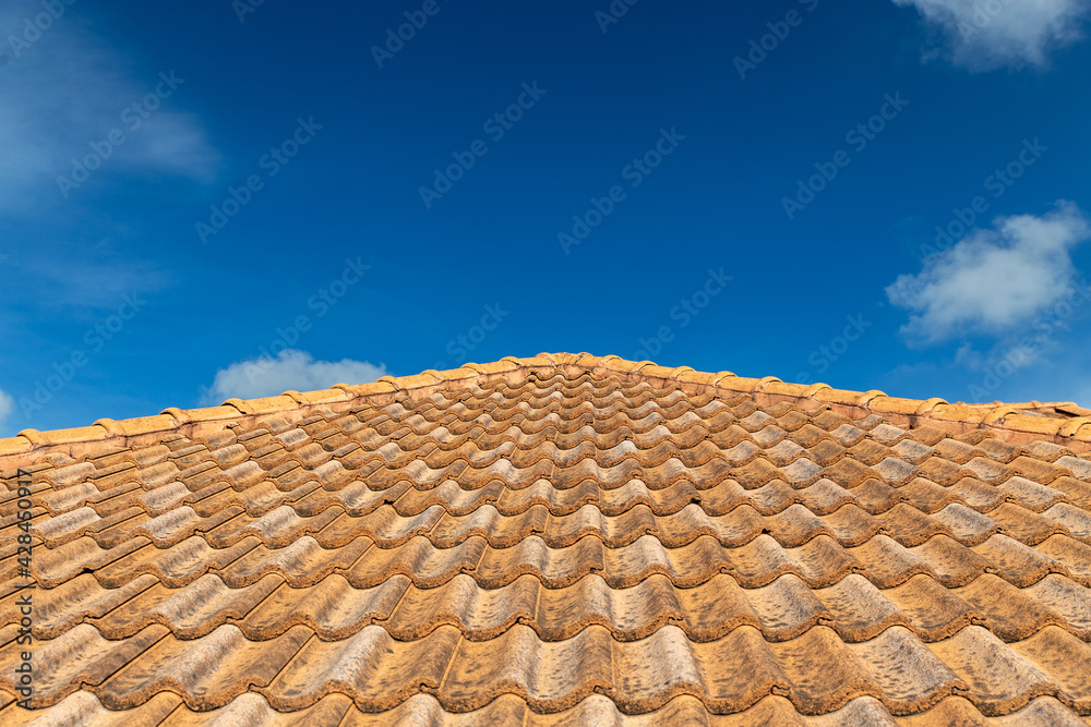 Close up of brown clay roof tiles. Red old dirty roof. Old roof tiles. Construction equipment build a house. Close up of brown clay roof tiles. Red old dirty roof. Old roof tiles. Construction equipment build a house.