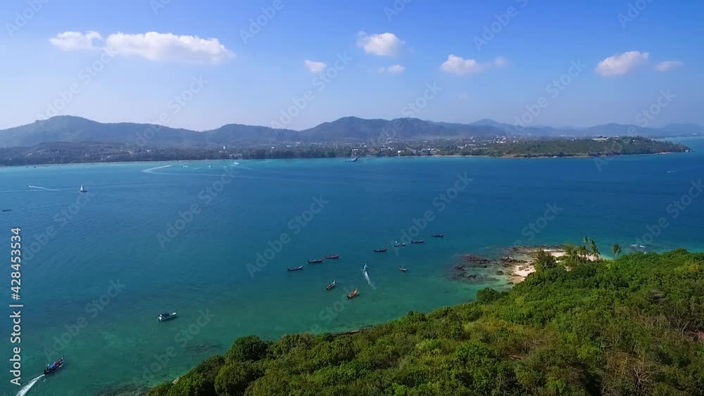Phuket Long Boat moored in the sea, bright emerald green water, tourism, snorkeling, White sand beach travel summer Thailand Phuket Long Boat moored in the sea, bright emerald green water, tourism, snorkeling, White sand beach travel summer Thailand